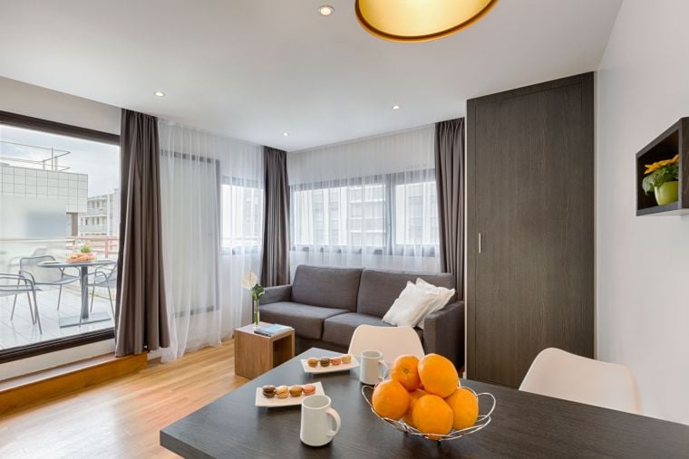 Living room of a 1-Bedroom Classic equipped with a sofa bed, a dining area and a terrace, apart hotel Paris 13