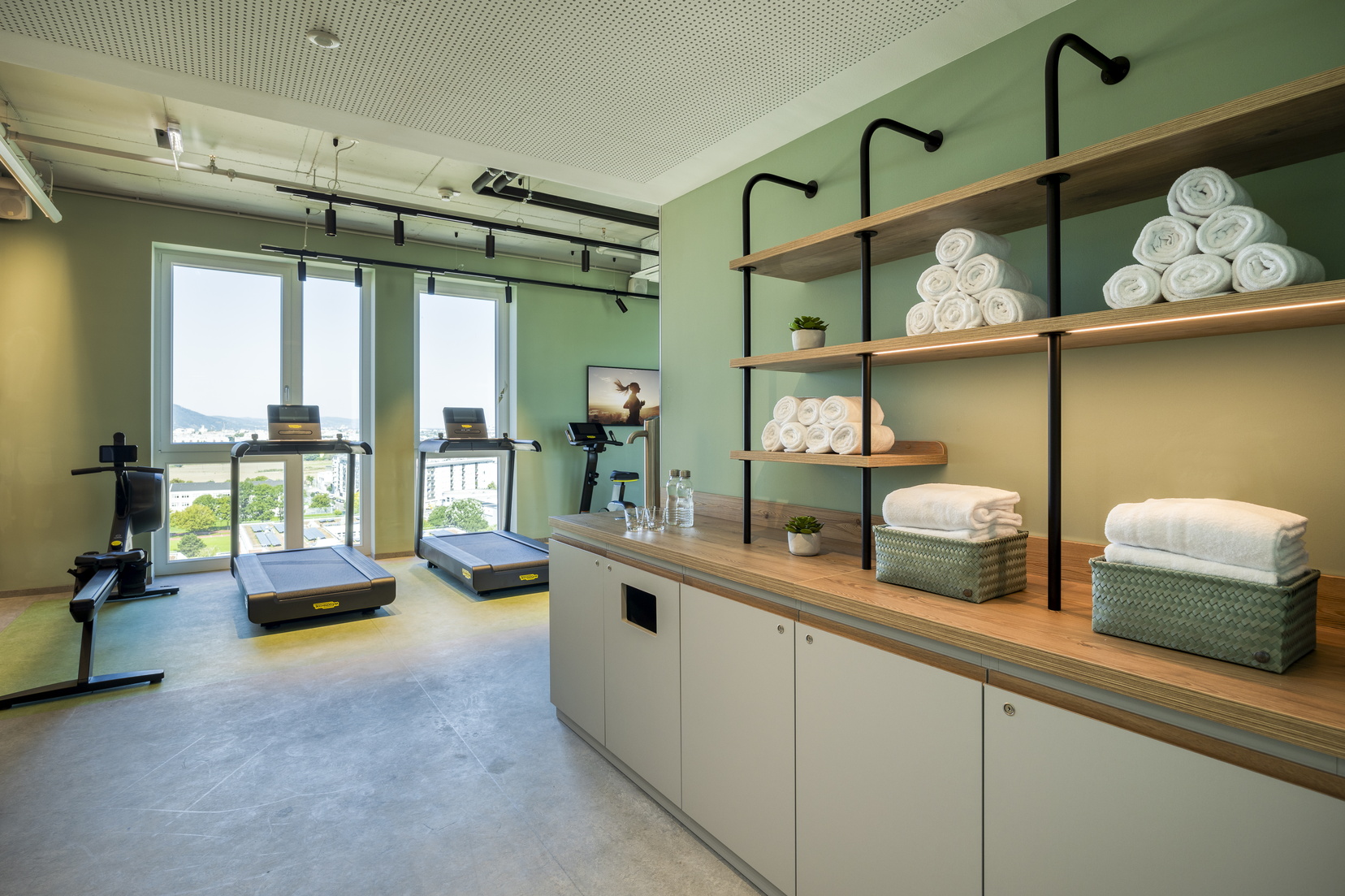 Gym equipped with treadmills, weights, bicycles, and elliptical machines