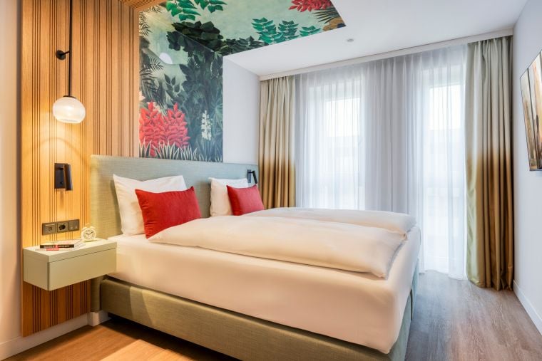 Bedroom of a One-Bedroom Executive Apartment with a double bed and TV