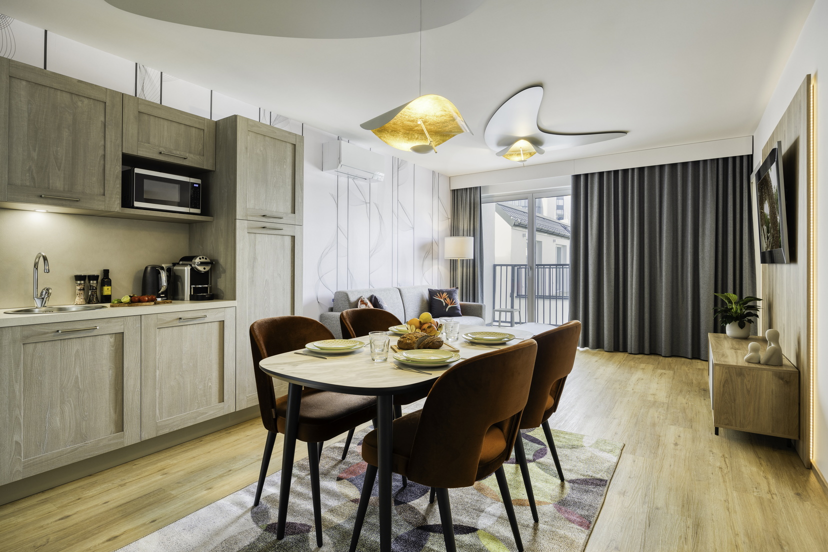 Living room of a 2-Bedroom Apartment equipped with a kitchen, a sofa bed, and a TV with Chromecast