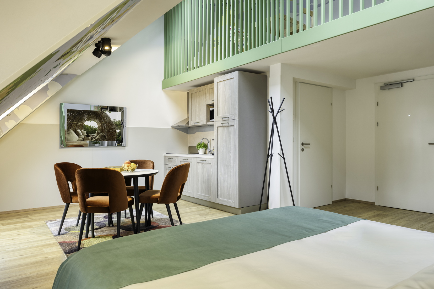 Living room of a Family Loft equipped with a double bed, a kitchen, and a TV with Chromecast