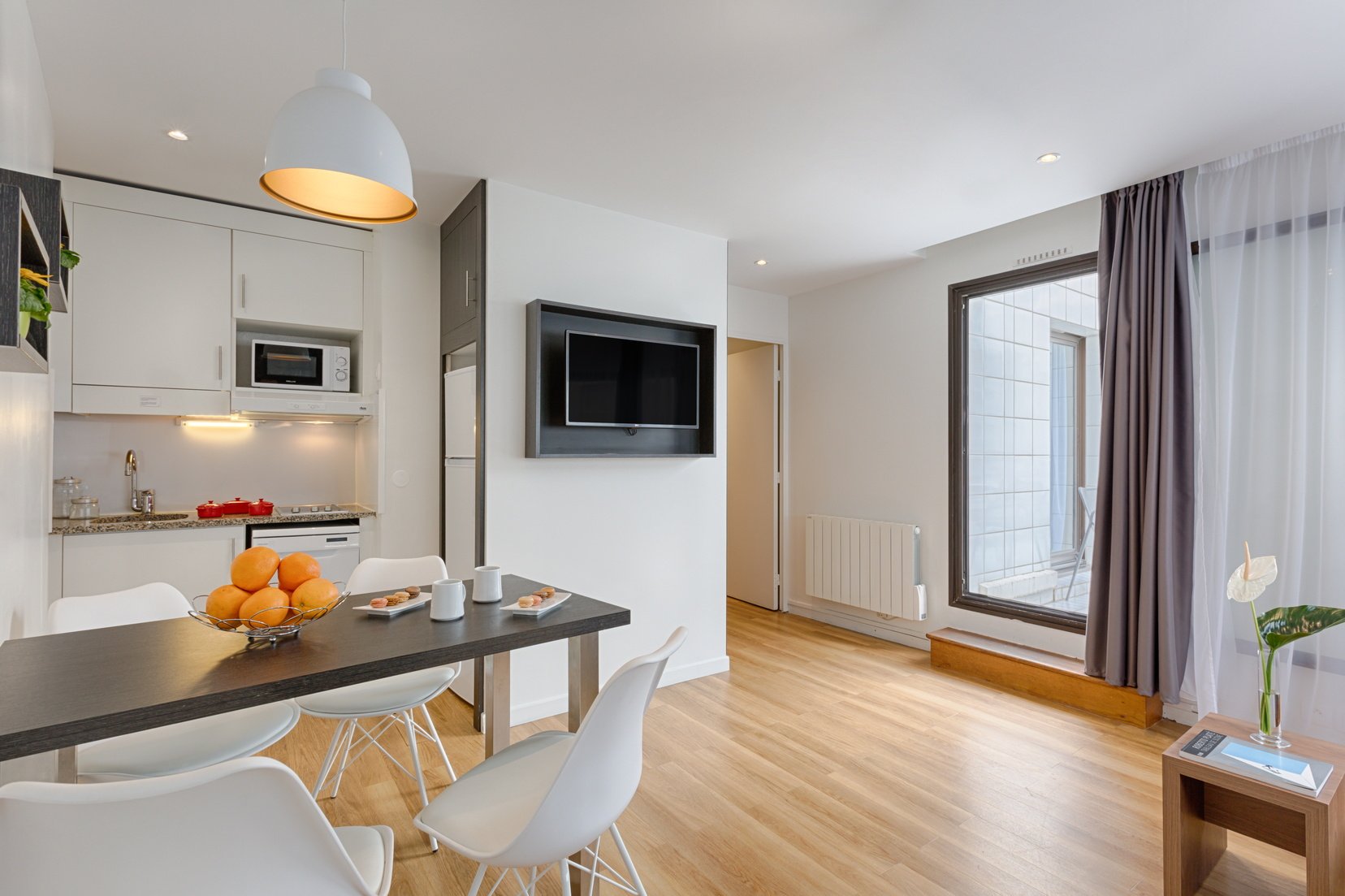 Fully equipped kitchen and dining area of a 1-Bedroom Classic, apart hotel Paris 13