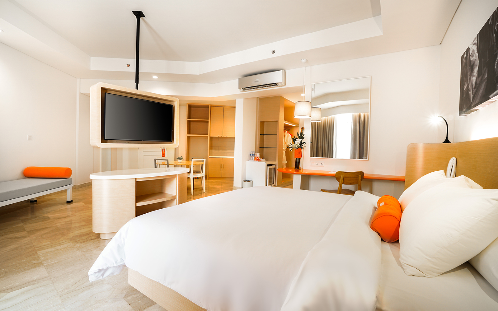 Bed and a TV at HARRIS Resort Batam Waterfront